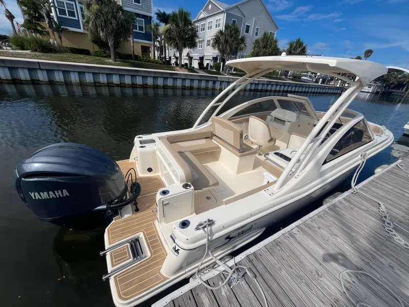 Slide: The Image of 2024 Scout 240 Dorado boat docked, featuring Yamaha outboard motor. - 5