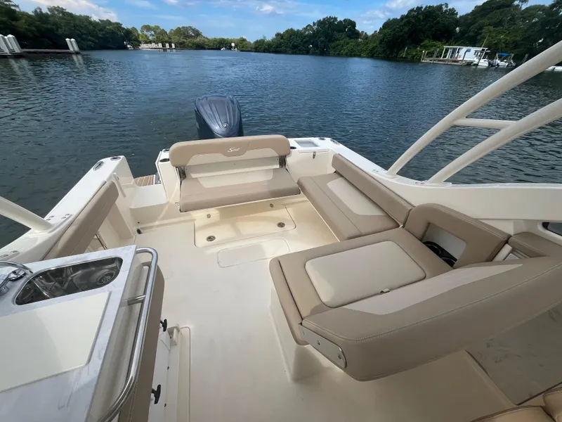 Slide: The Image of 2024 Scout 240 Dorado boat interior with seating and water view. - 8