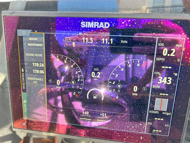 Slide: The Image of Simrad display on 2018 Tidewater 2700 Carolina Bay showing engine metrics and navigation data. - 11