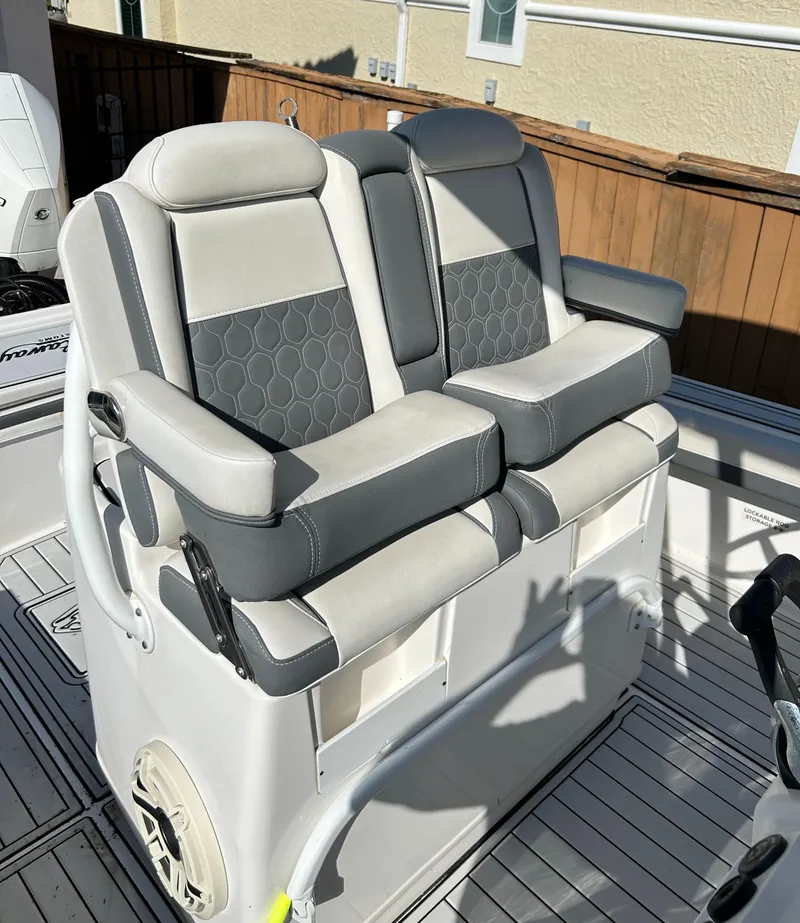 Slide: The Image of 2018 Tidewater 2700 Carolina Bay boat seats, gray and white upholstery, dual seating arrangement. - 12