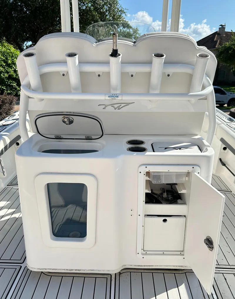 Slide: The Image of 2018 Tidewater 2700 Carolina Bay boat console with storage and rod holders. - 13