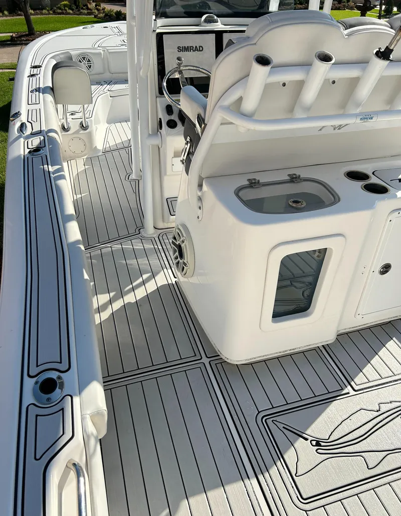 Slide: The Image of 2018 Tidewater 2700 Carolina Bay boat deck with rod holders and control panel. - 14