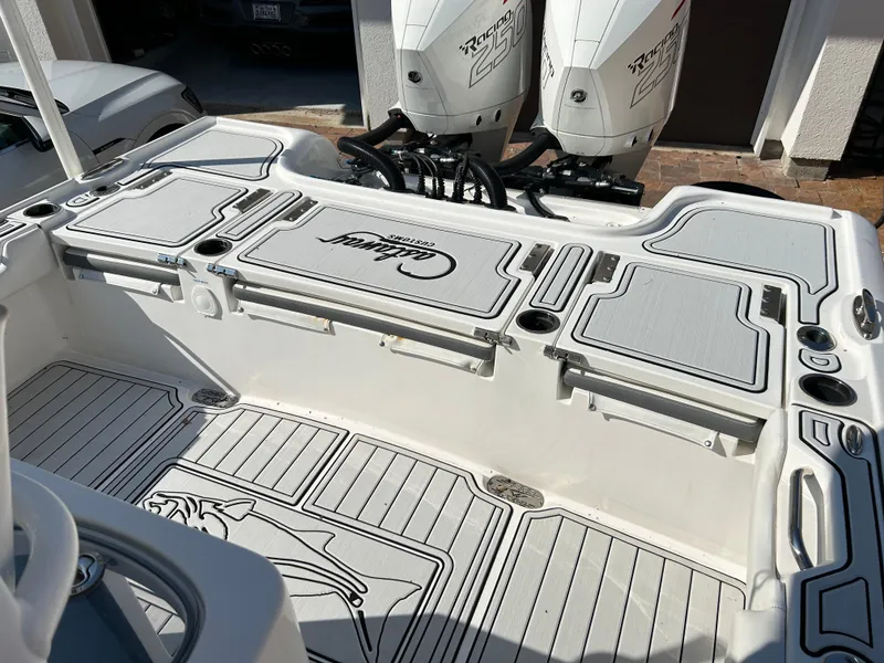 Slide: The Image of 2018 Tidewater 2700 Carolina Bay boat interior with dual engines and spacious deck layout. - 18