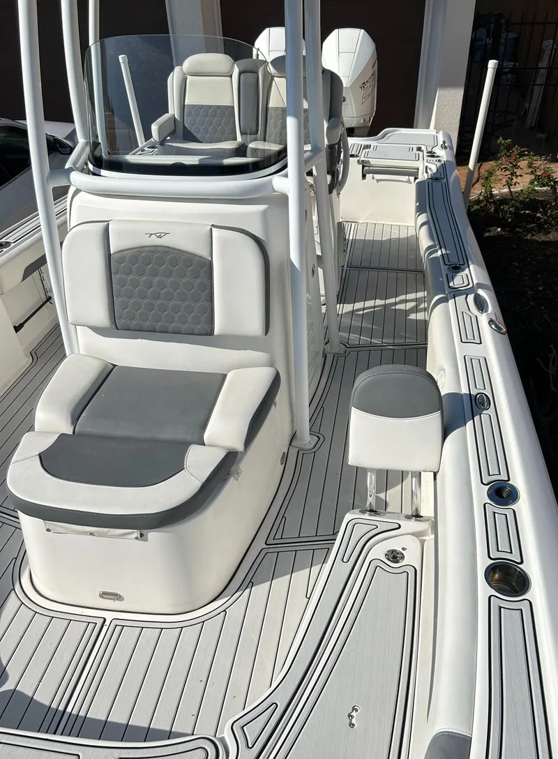 Slide: The Image of 2018 Tidewater 2700 Carolina Bay boat interior with seating and console. - 2