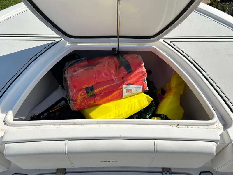 Slide: The Image of Open storage compartment on 2018 Tidewater 2700 Carolina Bay boat with safety gear. - 21