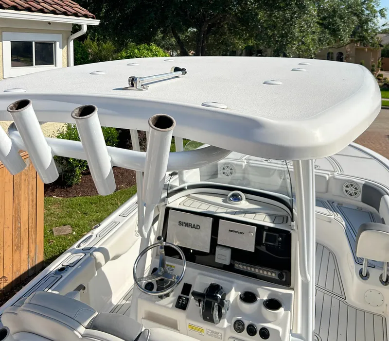 Slide: The Image of 2018 Tidewater 2700 Carolina Bay boat interior with helm, rod holders, and navigation equipment. - 22