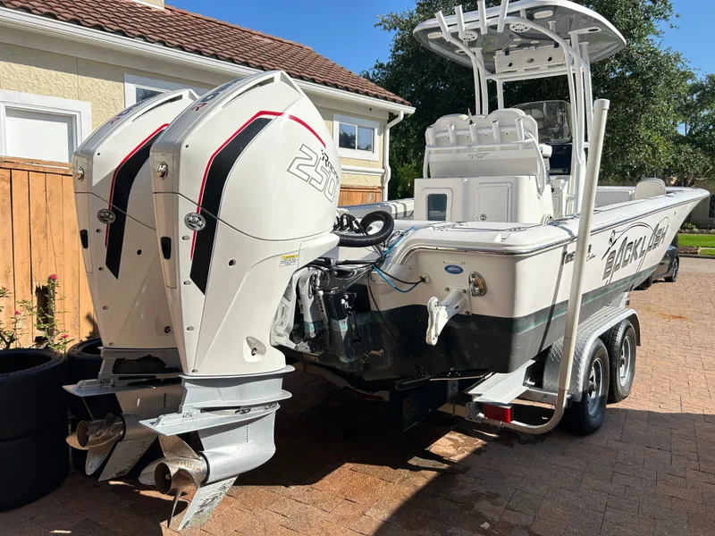 Slide: The Image of 2018 Tidewater 2700 Carolina Bay boat with dual engines on a trailer. - 24