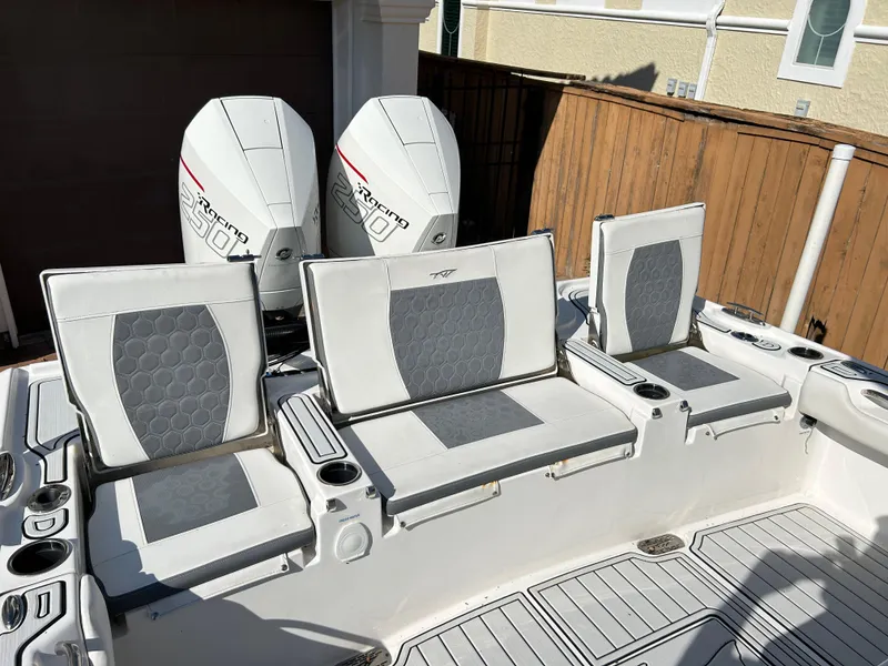 Slide: The Image of 2018 Tidewater 2700 Carolina Bay boat with dual engines and cushioned seating. - 6