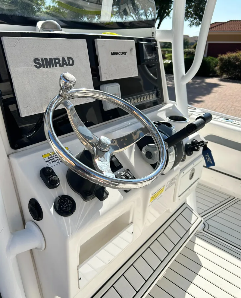Slide: The Image of 2018 Tidewater 2700 Carolina Bay boat console with Simrad and Mercury controls. - 9
