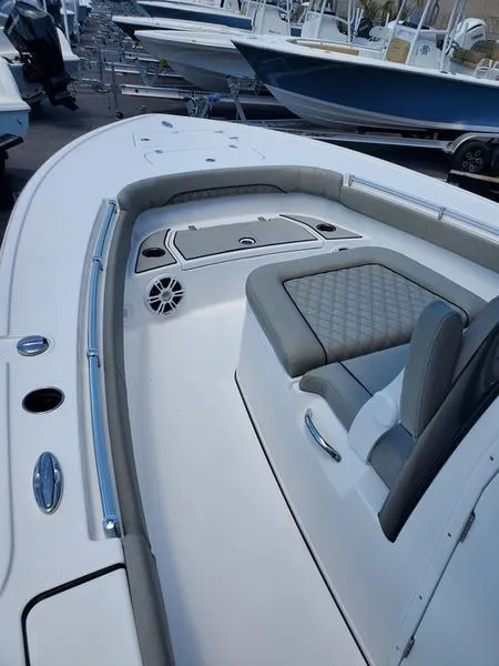 Slide: The Image of 2024 Sportsman Masters 267OE Bay boat interior with cushioned seating and storage compartments. - 3