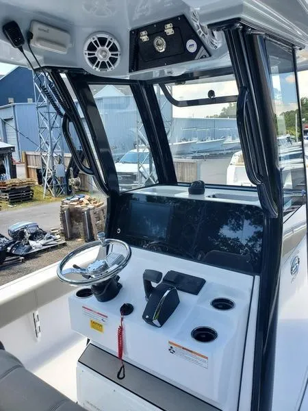 Slide: The Image of 2024 Sportsman Masters 267OE Bay boat console with steering wheel and controls. - 4
