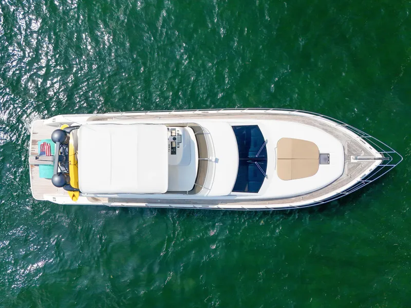 Slide: The Image of Aerial view of a 2006 Uniesse 58 yacht cruising on green waters. - 11