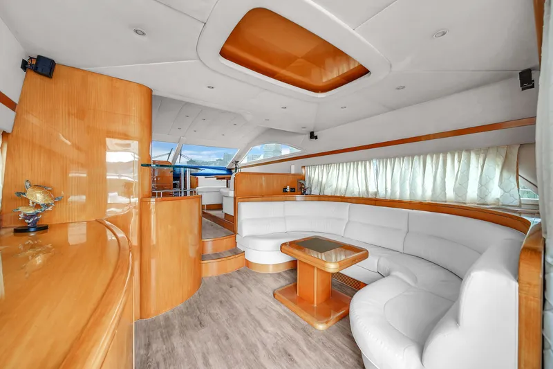 Slide: The Image of Luxurious interior of a 2006 Uniesse 58 yacht with white leather seating and wooden finishes. - 12