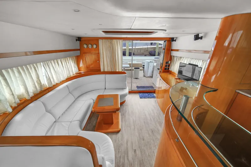 Slide: The Image of Luxurious interior of a 2006 Uniesse 58 yacht with white leather seating and wooden accents. - 13