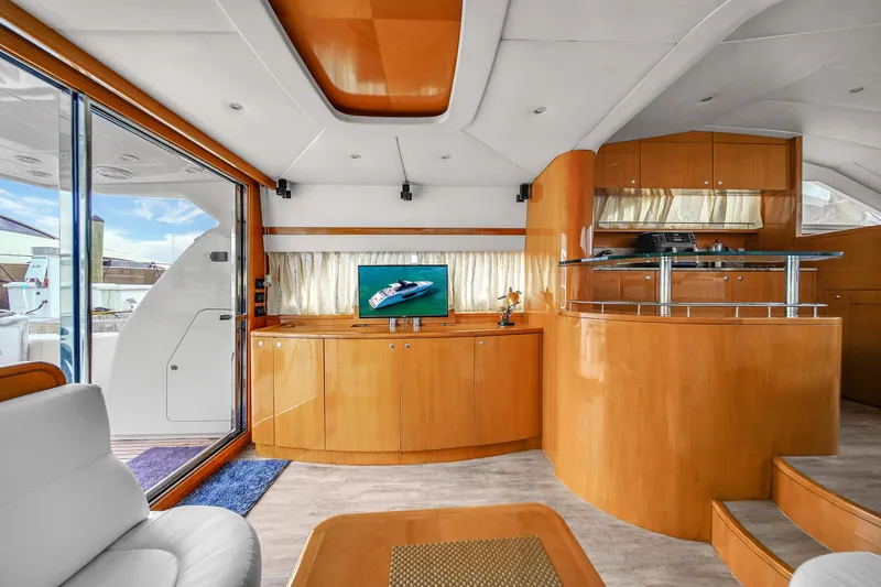 Slide: The Image of Interior of 2006 Uniesse 58 yacht with modern wood finishes and entertainment center. - 15