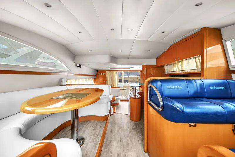 Slide: The Image of Luxurious interior of a 2006 Uniesse 58 yacht with modern seating and dining area. - 17