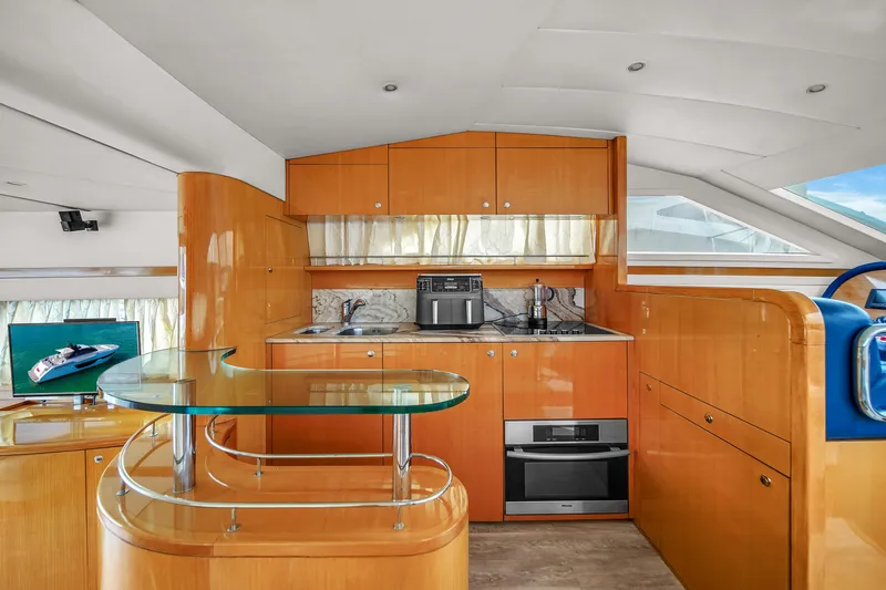 Slide: The Image of Luxurious kitchen area inside a 2006 Uniesse 58 yacht with modern appliances. - 18