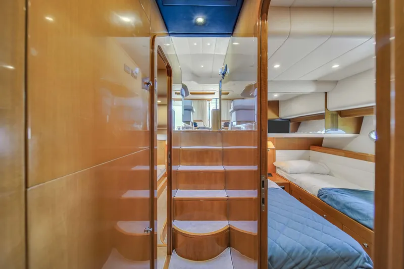 Slide: The Image of Interior of 2006 Uniesse 58 yacht with wooden stairs and cozy bedroom. - 26