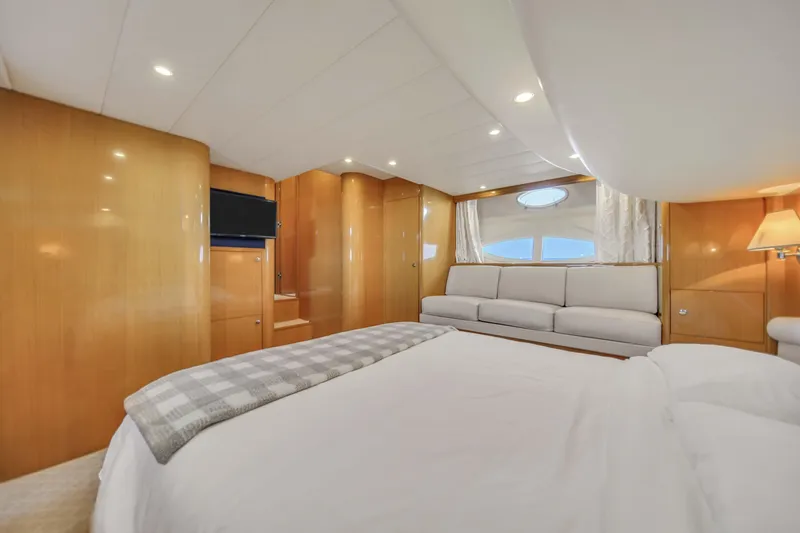 Slide: The Image of Luxurious bedroom interior of 2006 Uniesse 58 yacht with modern furnishings and ample lighting. - 28