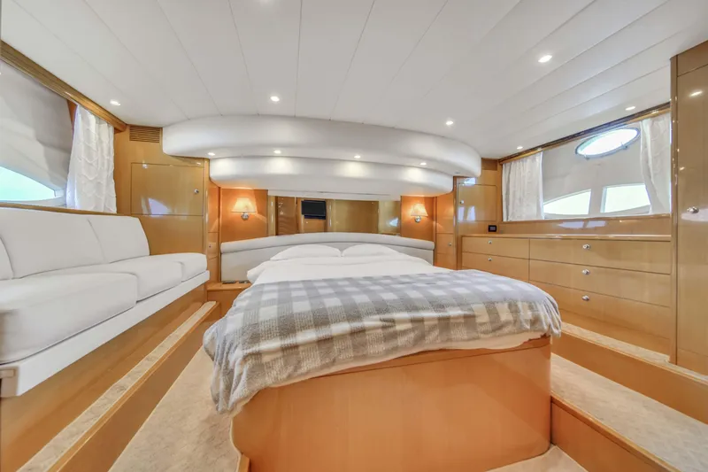 Slide: The Image of Luxurious master bedroom in a 2006 Uniesse 58 yacht with modern furnishings. - 29