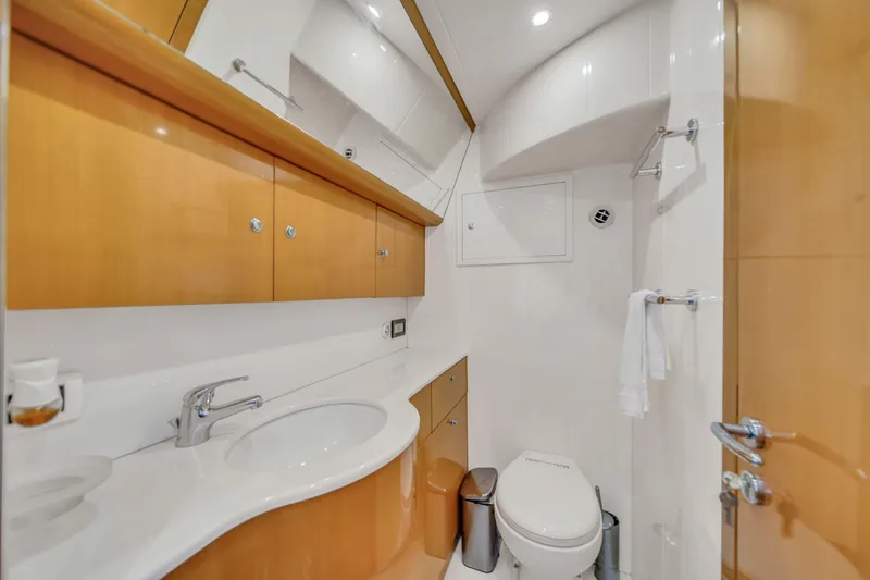 Slide: The Image of Luxurious bathroom in a 2006 Uniesse 58 yacht with modern fixtures and wooden cabinetry. - 30