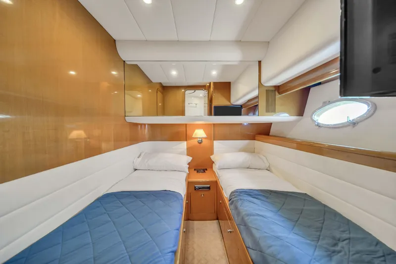 Slide: The Image of Twin cabin interior of 2006 Uniesse 58 yacht with wood paneling and blue bedding. - 34