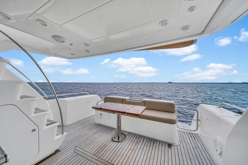 Slide: The Image of Luxury 2006 Uniesse 58 yacht deck with ocean view, seating, and table. - 35