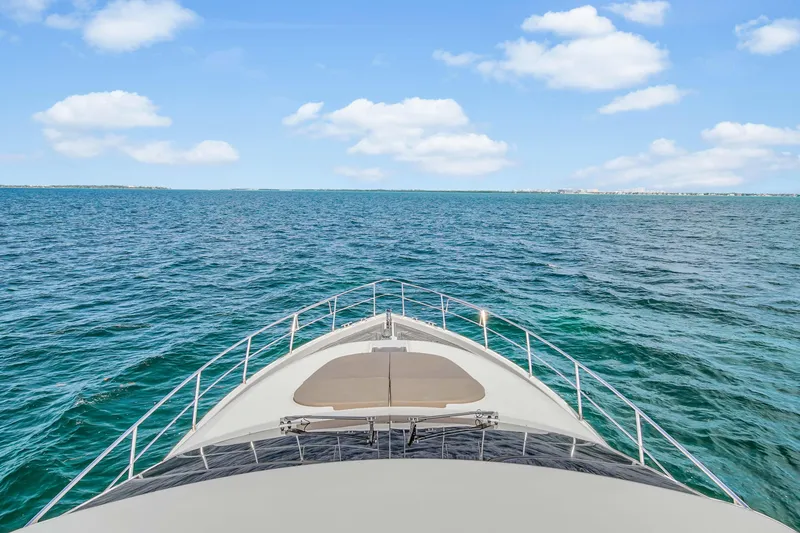 Slide: The Image of Bow view of 2006 Uniesse 58 yacht cruising on open blue sea. - 44