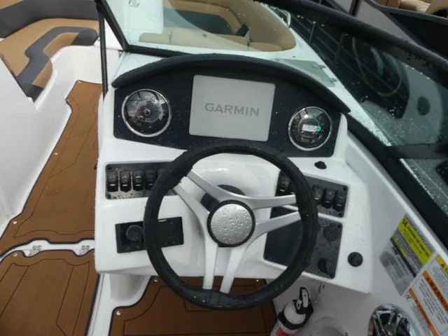 Slide: The Image of 2024 Hurricane SunDeck 2486 OB boat cockpit with tan and black captain's chair. - 12