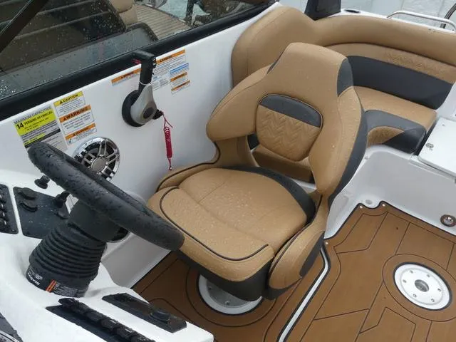 Slide: The Image of 2024 Hurricane SunDeck 2486 OB boat interior with tan and black seating. - 13