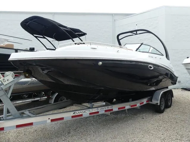 Slide: The Image of 2024 Hurricane SunDeck 2486 OB boat on a trailer, front view. - 2