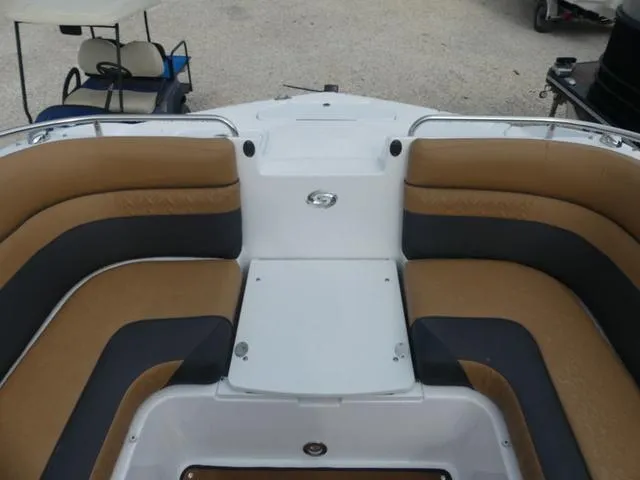 Slide: The Image of 2024 Hurricane SunDeck 2486 OB boat interior with tan seating and dual windshields. - 20