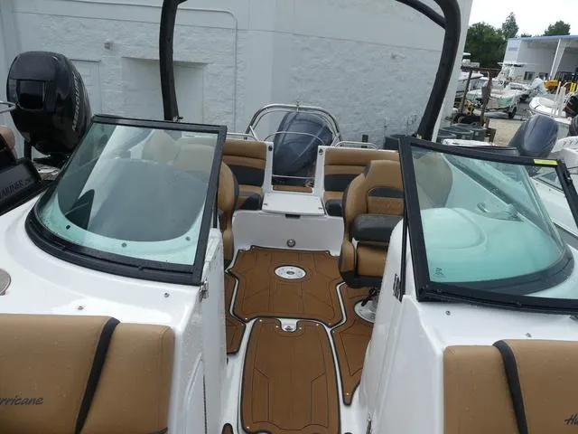 Slide: The Image of 2024 Hurricane SunDeck 2486 OB boat interior with tan and black seating. - 21