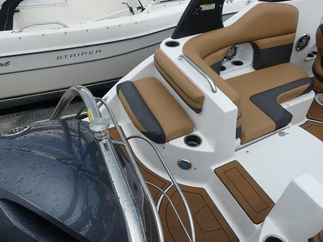 Slide: The Image of 2024 Hurricane SunDeck 2486 OB boat interior with tan and black seating. - 8