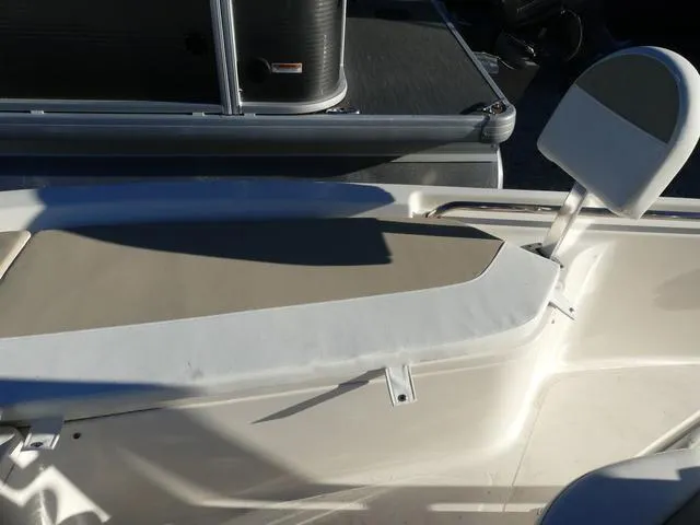 Slide: The Image of 2024 Bulls Bay 2200 boat interior with beige seating and white trim. - 12