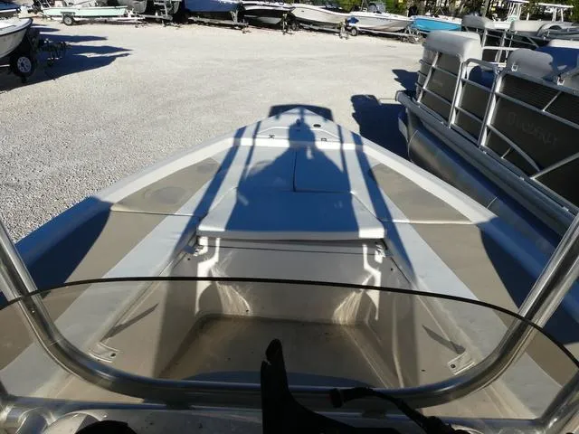 Slide: The Image of 2024 Bulls Bay 2200 boat deck view in a marina with surrounding boats. - 17