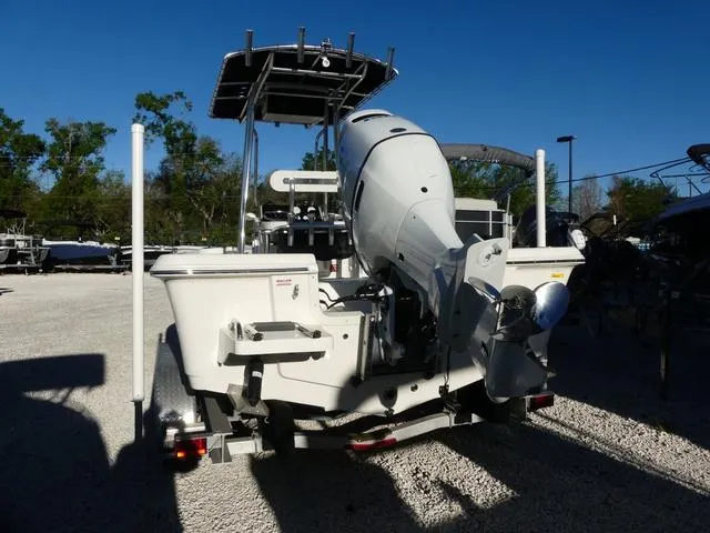 Slide: The Image of 2024 Bulls Bay 2200 boat with powerful outboard motor, parked on gravel lot. - 3
