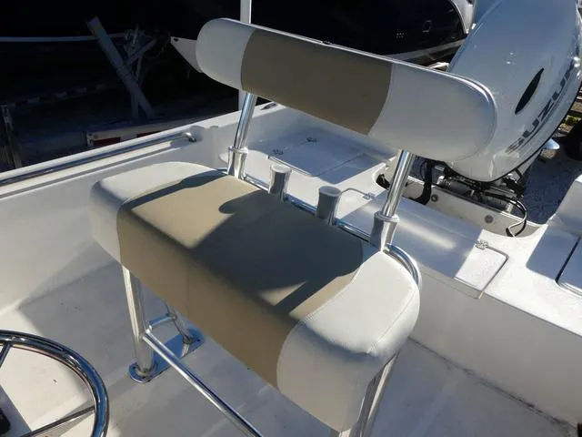 Slide: The Image of 2024 Bulls Bay 2200 boat seat with rod holders and white upholstery. - 9