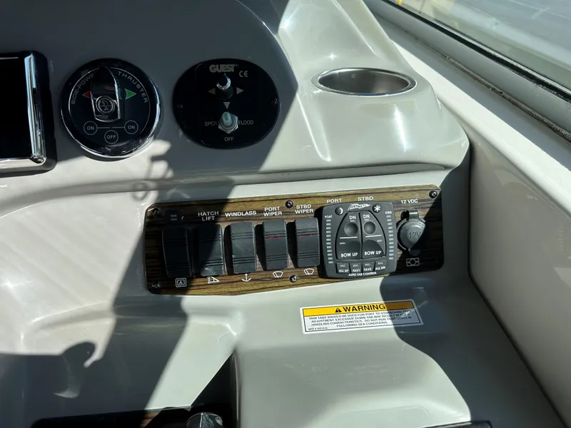 Slide: The Image of Control panel of a 2012 Bayliner 335 Cruiser boat with various switches and dials. - 12