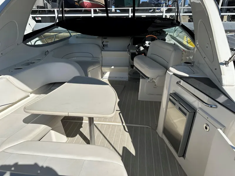 Slide: The Image of Interior of 2012 Bayliner 335 Cruiser with seating, table, and kitchenette. - 13