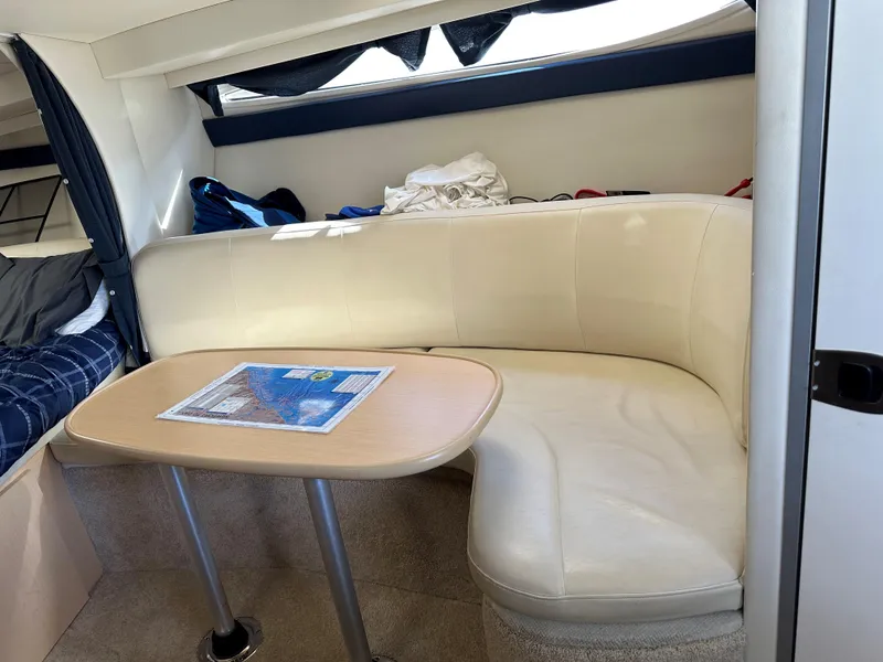 Slide: The Image of Interior of 2012 Bayliner 335 Cruiser with beige seating and table. - 14