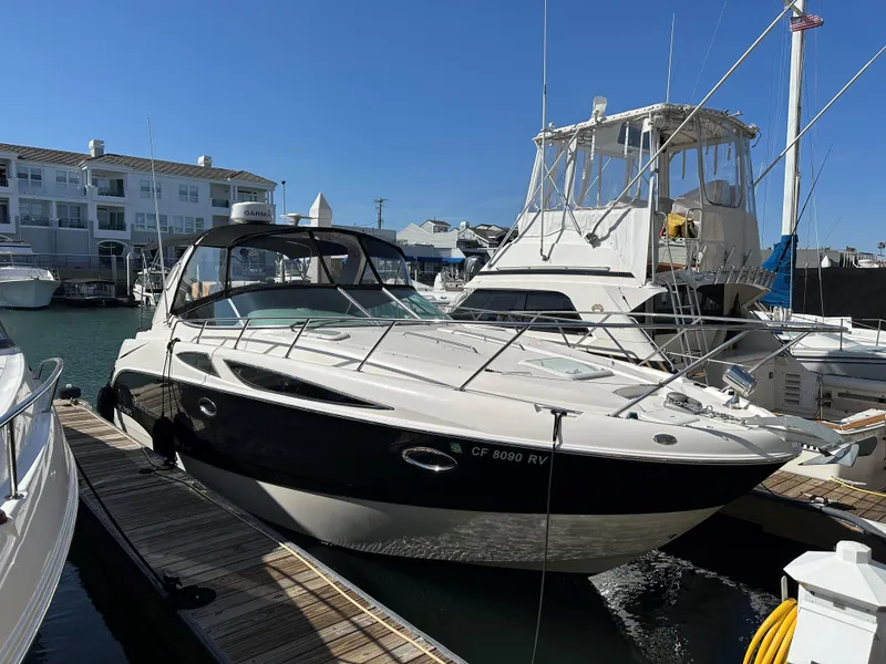 Slide: The Image of 2012 Bayliner 335 Cruiser docked at a marina on a sunny day. - 23