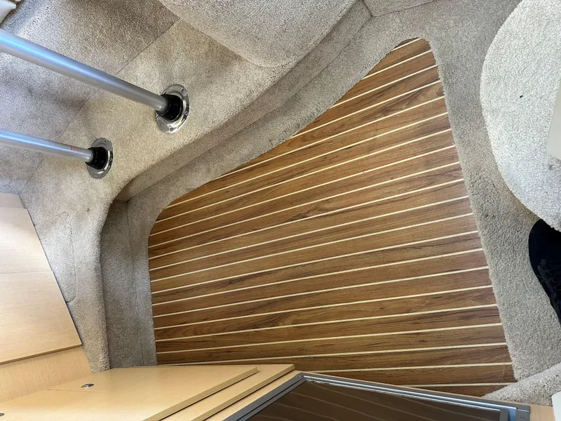 Slide: The Image of Interior flooring of 2012 Bayliner 335 Cruiser with wood and carpet finish. - 24