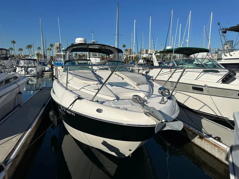 Slide: The Image of 2012 Bayliner 335 Cruiser docked at a marina with other boats. - 9
