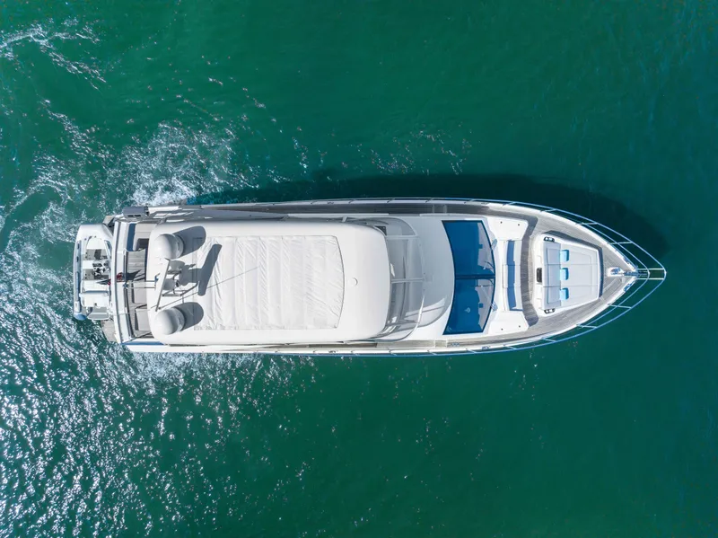 Slide: The Image of Aerial view of 2015 Absolute 64 FLY yacht cruising on clear blue water. - 4