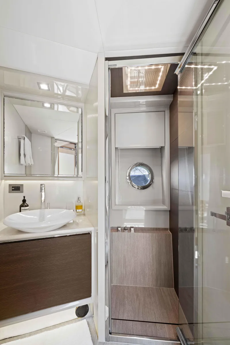 Slide: The Image of Luxurious bathroom on 2015 Absolute 64 FLY yacht with modern fixtures and porthole window. - 6