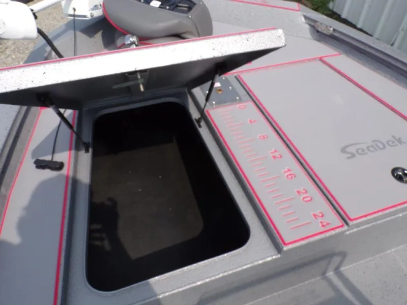 Slide: The Image of 2024 Xpress H190Bay boat with open storage compartment and SeaDek measuring ruler. - 12