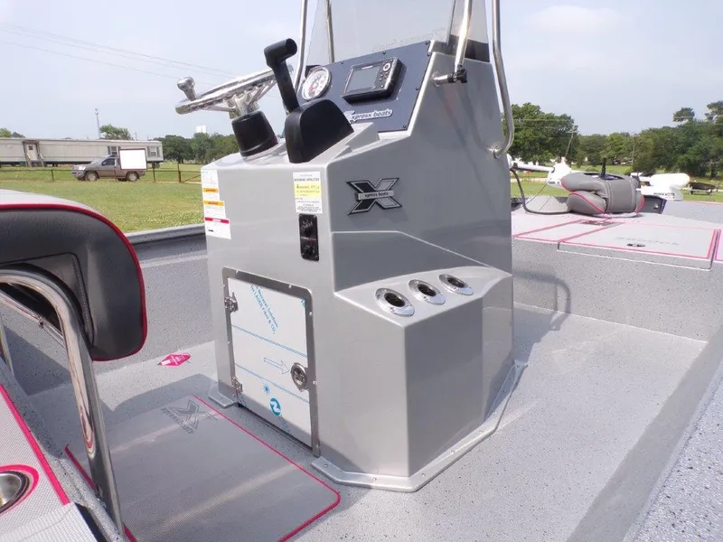Slide: The Image of 2024 Xpress H190Bay boat console with steering wheel, gauges, and rod holders. - 6
