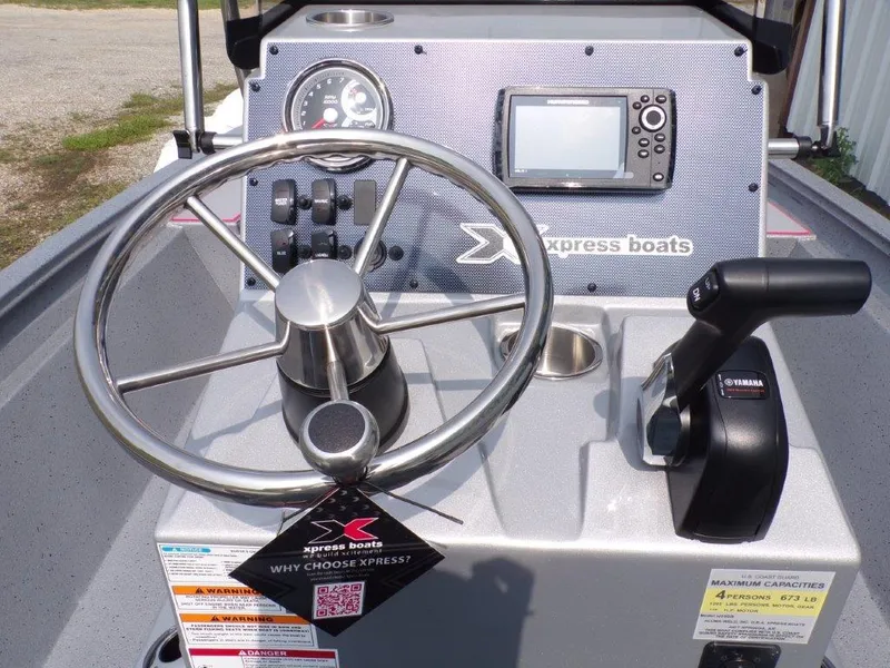 Slide: The Image of 2024 Xpress H190Bay boat console with steering wheel, controls, and display. - 7