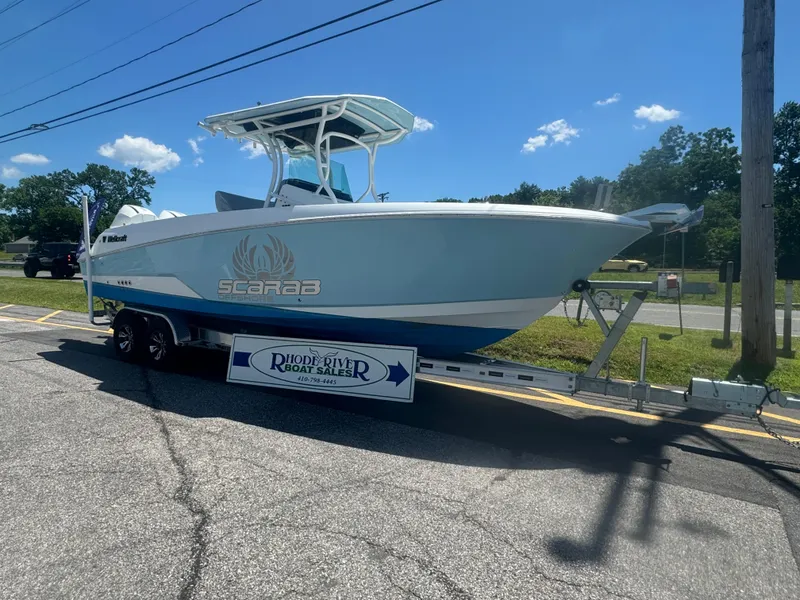 Slide: The Image of 2022 Wellcraft 262 Fisherman boat on a trailer under a clear blue sky. - 10
